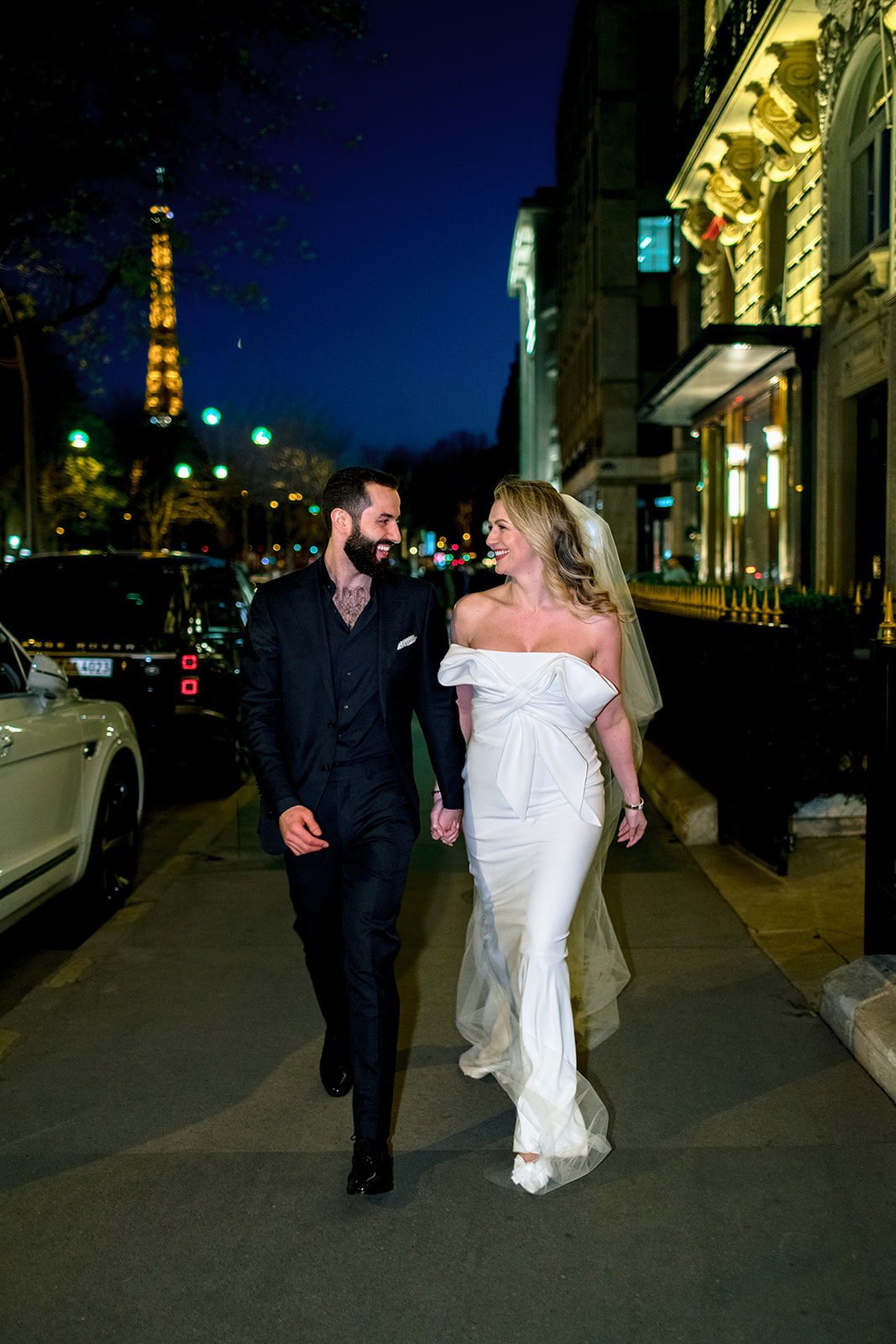 Wedding couple walking through Paris at night near Hôtel Plaza Athénée